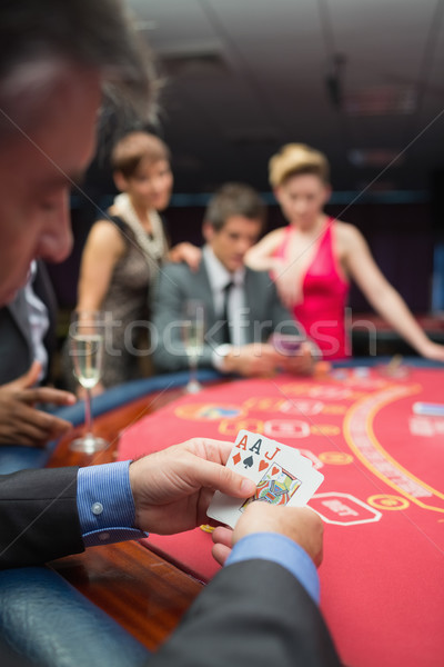 Homme regarder cartes poker jeu casino [[stock_photo]] © wavebreak_media