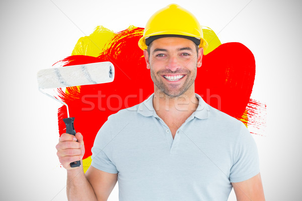 Composite image of portrait of manual worker holding paint rolle Stock photo © wavebreak_media