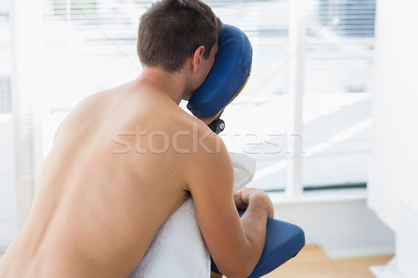 Człowiek posiedzenia masażu krzesło widok z tyłu półnagi Zdjęcia stock © wavebreak_media