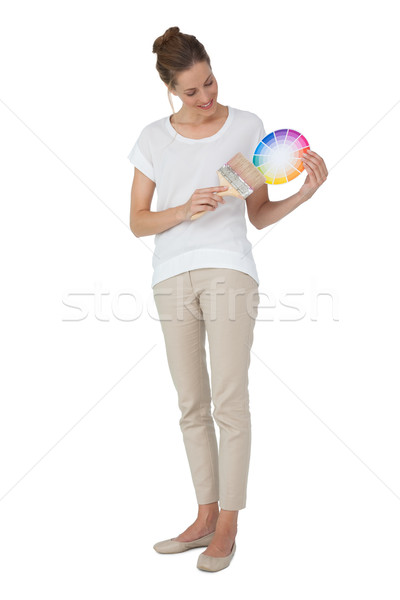 Full length of a woman with paint samples and paintbrush Stock photo © wavebreak_media