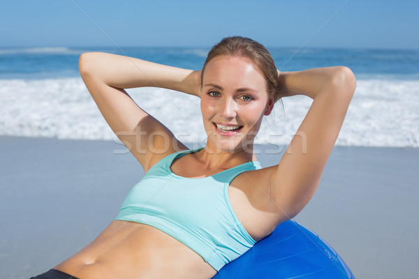 Fit woman lying on exercise ball at the beach doing sit ups Stock photo © wavebreak_media