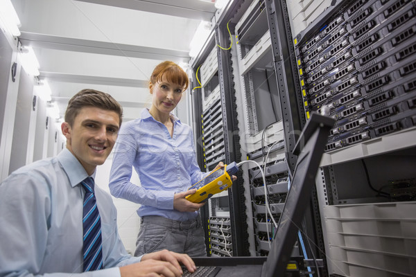 Team of technicians using digital cable analyser on servers Stock photo © wavebreak_media