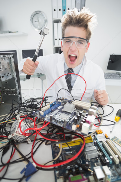 Angry computer engineer holding hammer over console Stock photo © wavebreak_media