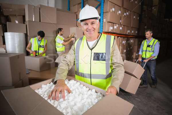 Warehouse workers in yellow vests preparing a shipment Stock photo © wavebreak_media