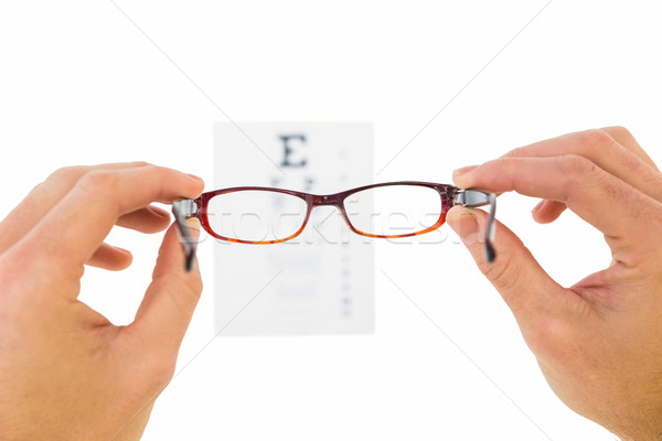 Glasses held up to read eye test Stock photo © wavebreak_media