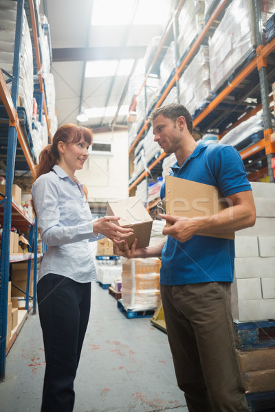Delivery man passing parcel to warehouse manager Stock photo © wavebreak_media