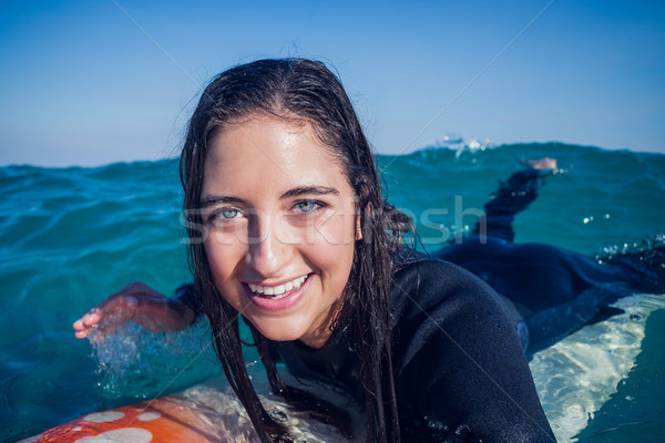 woman in wetsuit with a surfboard on a sunny day Stock photo © wavebreak_media