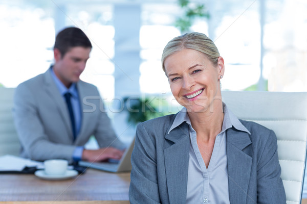 Smiling businesswoman looking at camera Stock photo © wavebreak_media