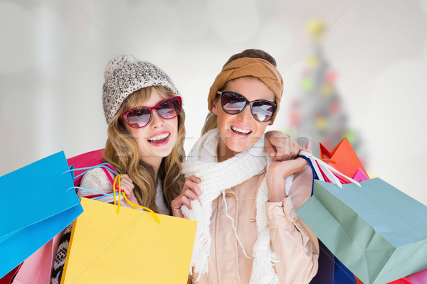 Composite image of beautiful women holding shopping bags looking Stock photo © wavebreak_media