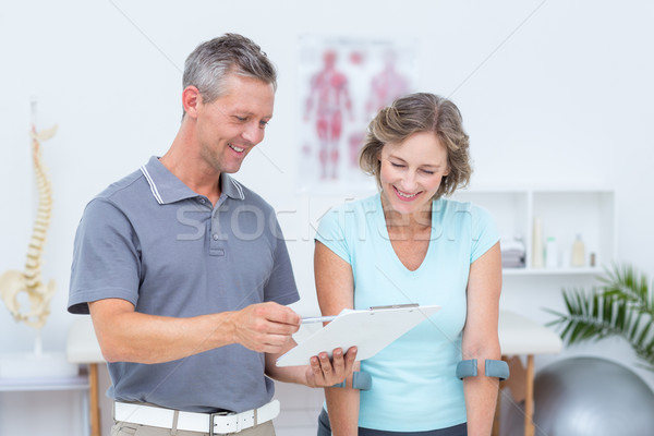 Woman using crutch and talking with her doctor Stock photo © wavebreak_media