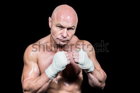 Stock photo: Strong bodybuilder flexing his bicep