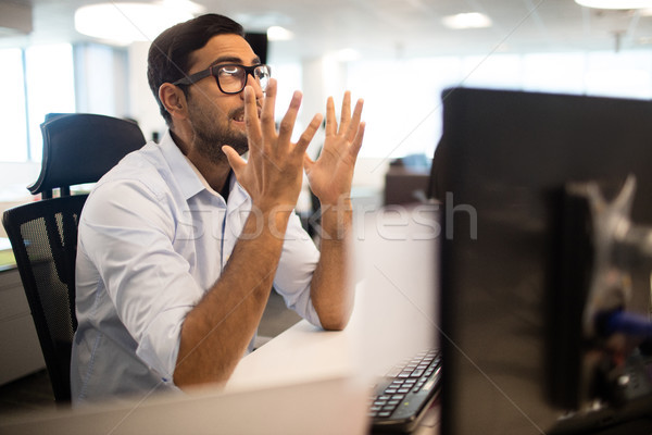 Frustrated businessman clenching teeth in office Stock photo © wavebreak_media