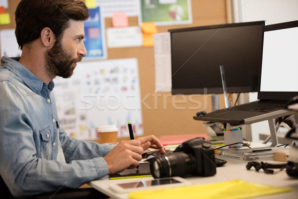 Serious designer editing image in creative office Stock photo © wavebreak_media
