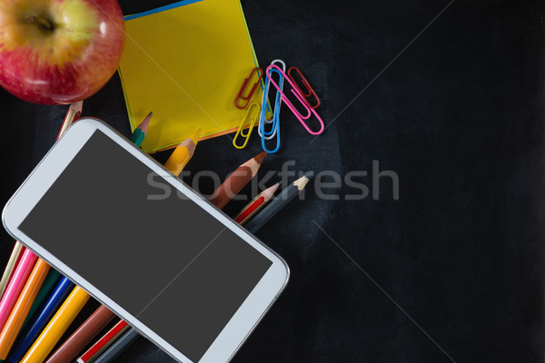 Various stationery with apple and mobile phone Stock photo © wavebreak_media