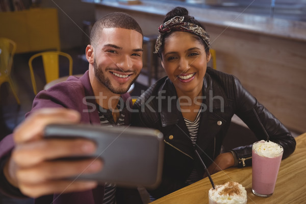Smiling man with friend taking selfie in cafe Stock photo © wavebreak_media