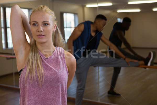 Dancer with friend stretching at studio Stock photo © wavebreak_media