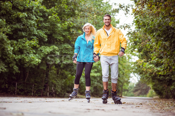 Stock photo: Happy couple roller blading together