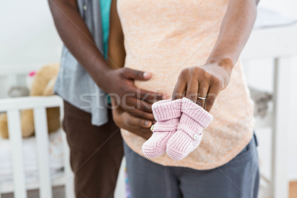 Pregnant couple holding pink baby shoes Stock photo © wavebreak_media