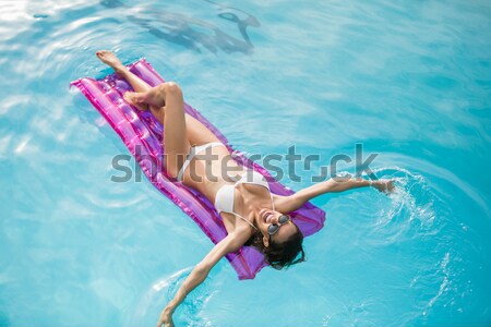 Boldog fiatal nő megnyugtató felfújható tutaj úszómedence Stock fotó © wavebreak_media