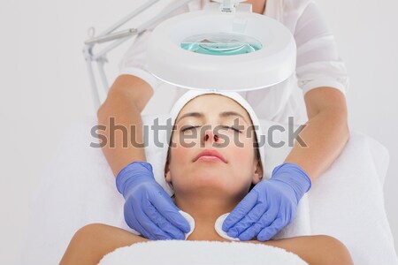 Stock photo: Masseuse cleaning woman face with cotton swabs