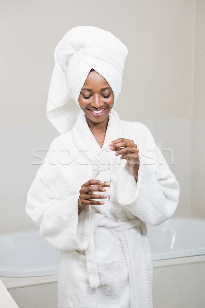 Belle femme pilule verre eau salle de bain maison [[stock_photo]] © wavebreak_media