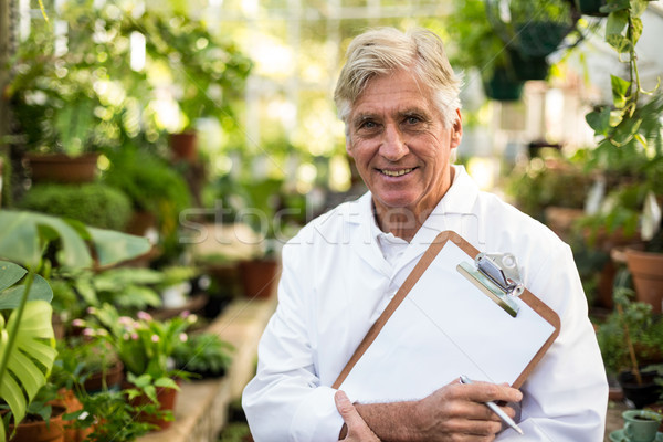 Male scientist holding clipboard at greenhouse Stock photo © wavebreak_media
