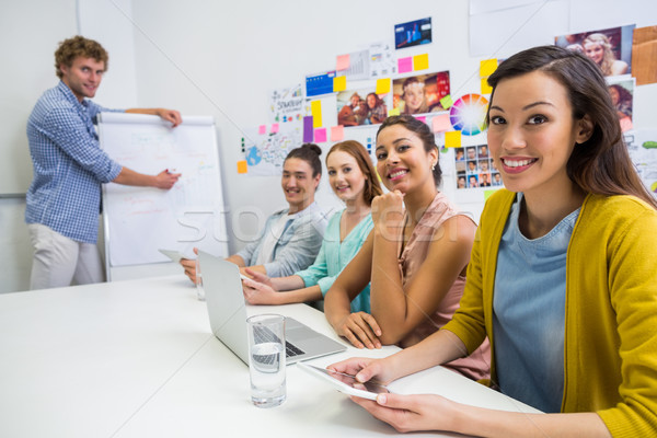 Stock photo: Portrait of smiling executives sitting in conference room during meeting