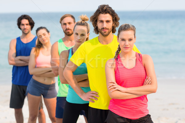 Friends in sports clothing standing at beach Stock photo © wavebreak_media