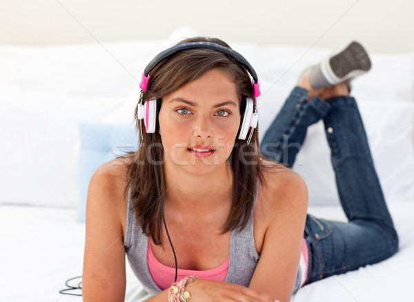 Hermosa adolescente escuchar música cama sesión música Foto stock © wavebreak_media