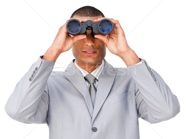 Serious young businessman looking through binoculars  Stock photo © wavebreak_media