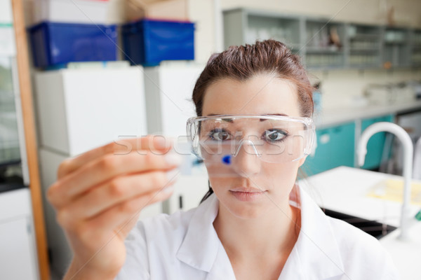 Stock photo: Cute science student looking at a microscope slide in a laboratory