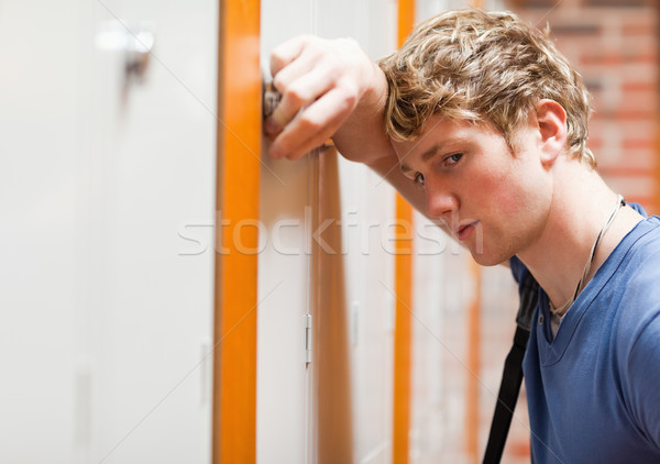 Close up of a lonely student leaning on a locker in a corridor Stock photo © wavebreak_media