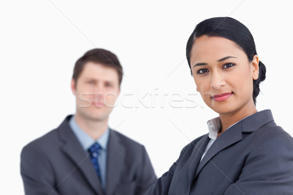 Close up of confident saleswoman with co-worker behind her against a white background Stock photo © wavebreak_media