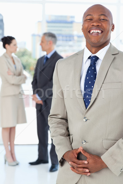 Young executive laughing while standing upright and crossing his hands Stock photo © wavebreak_media