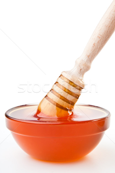 Honey dipper to the surface on  the honey bowl against a white background Stock photo © wavebreak_media