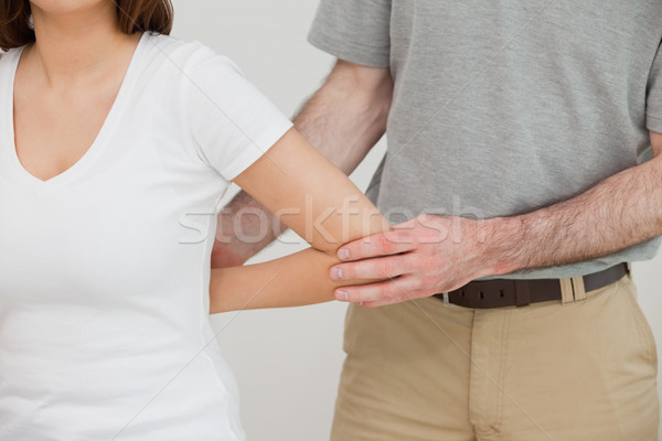 Close-up of a doctor examining the arm of a patient in a room Stock photo © wavebreak_media
