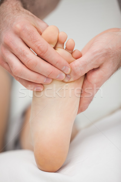 Foot being touched by a chiropodist in a room Stock photo © wavebreak_media