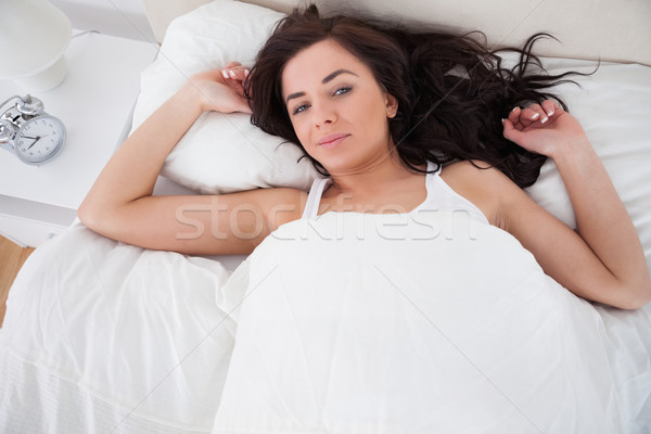 Stock photo: Peaceful woman lying while waking up in her bedroom