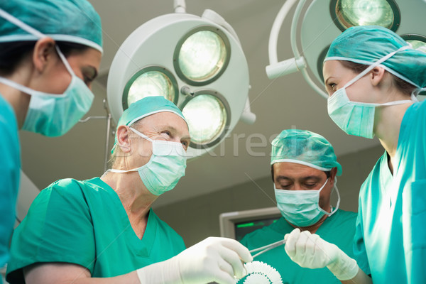 Surgeon team working together in a surgical room Stock photo © wavebreak_media