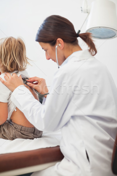 Doctor examining the breathing of a child in examination room Stock photo © wavebreak_media