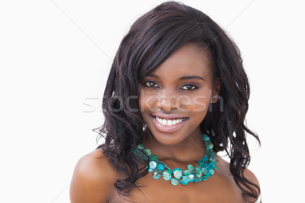 Woman while wearing a blue necklace against white background Stock photo © wavebreak_media