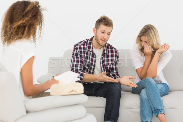 Man speaking to therapist at couples therapy while woman is cryi Stock photo © wavebreak_media