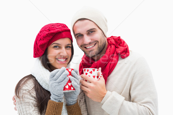 Attractive young couple in warm clothes holding mugs Stock photo © wavebreak_media