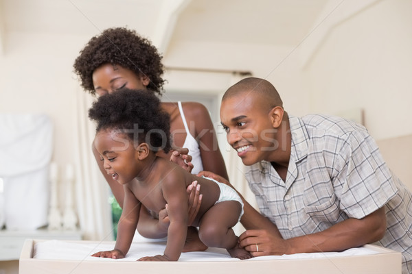 Stock photo: Happy parents with their baby girl in the park