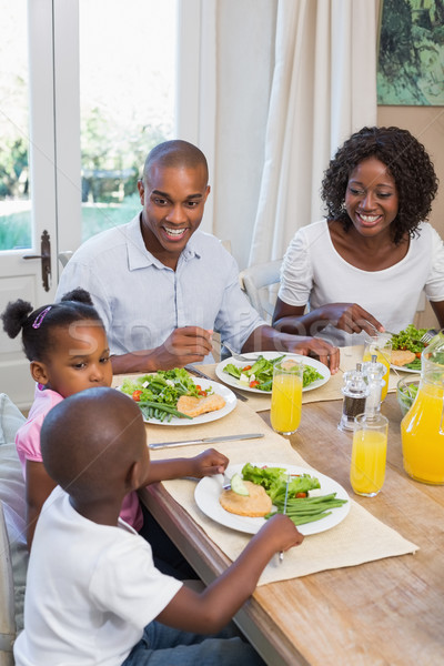 Happy family enjoying a healthy meal together Stock photo © wavebreak_media
