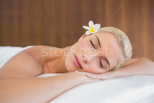 Beautiful woman lying on massage table at spa center Stock photo © wavebreak_media