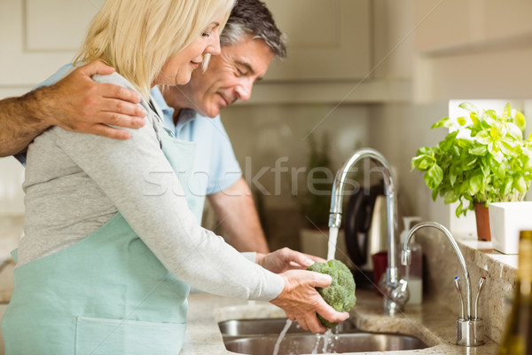 Stock photo: Happy mature couple washing broccoli 