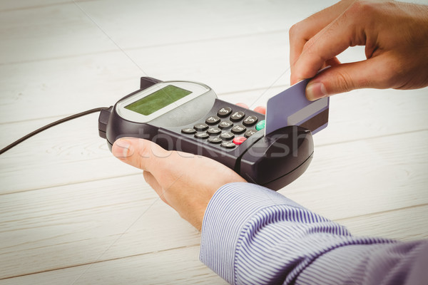 Man swiping his credit card Stock photo © wavebreak_media