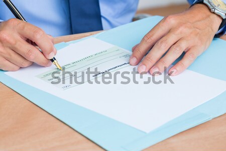 Businessman writing a contrat before signing it Stock photo © wavebreak_media