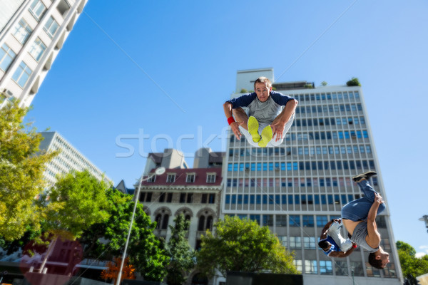 Happy friends doing parkour in the city Stock photo © wavebreak_media